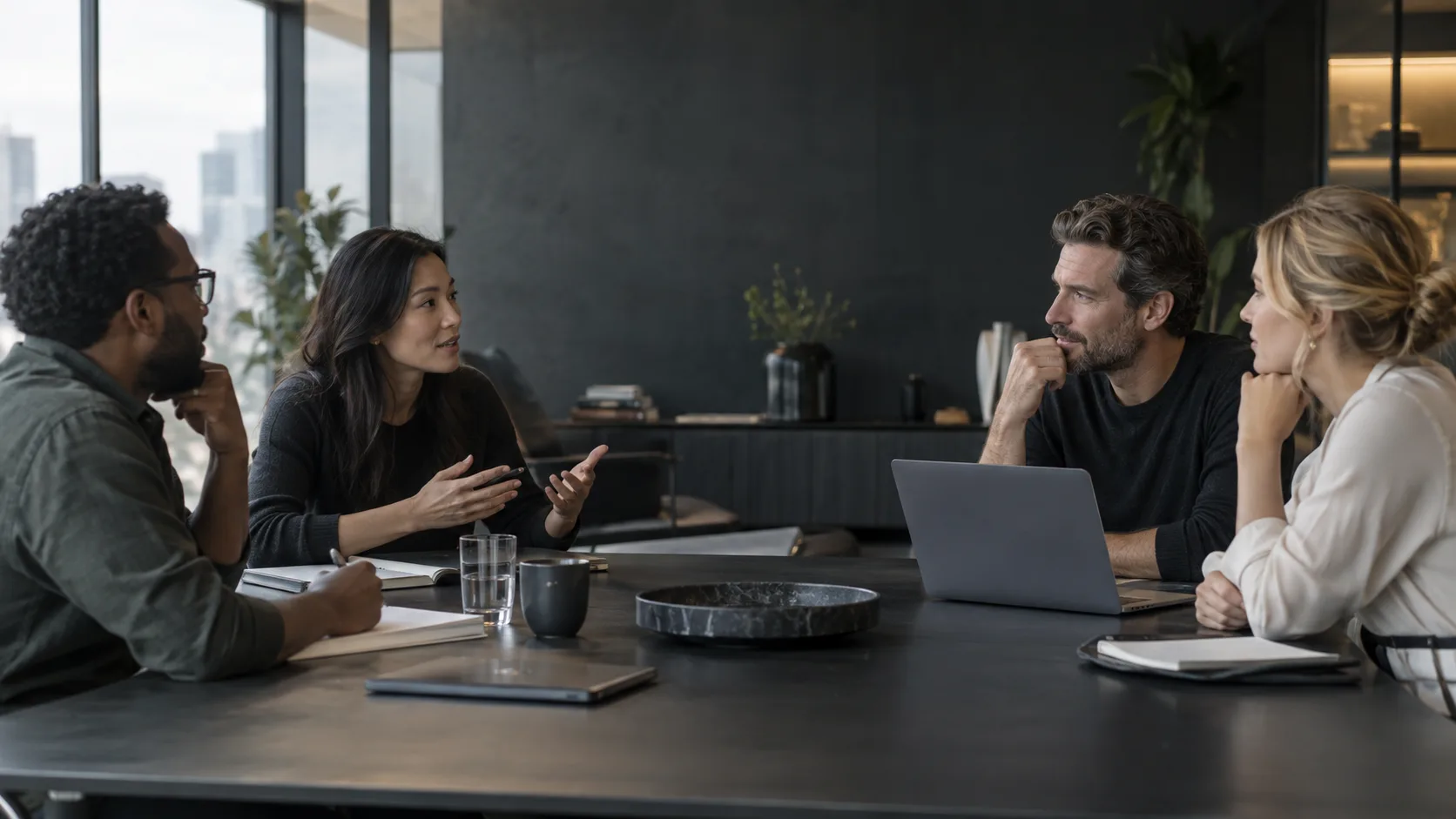 Four people talking in a meeting room while using live translation